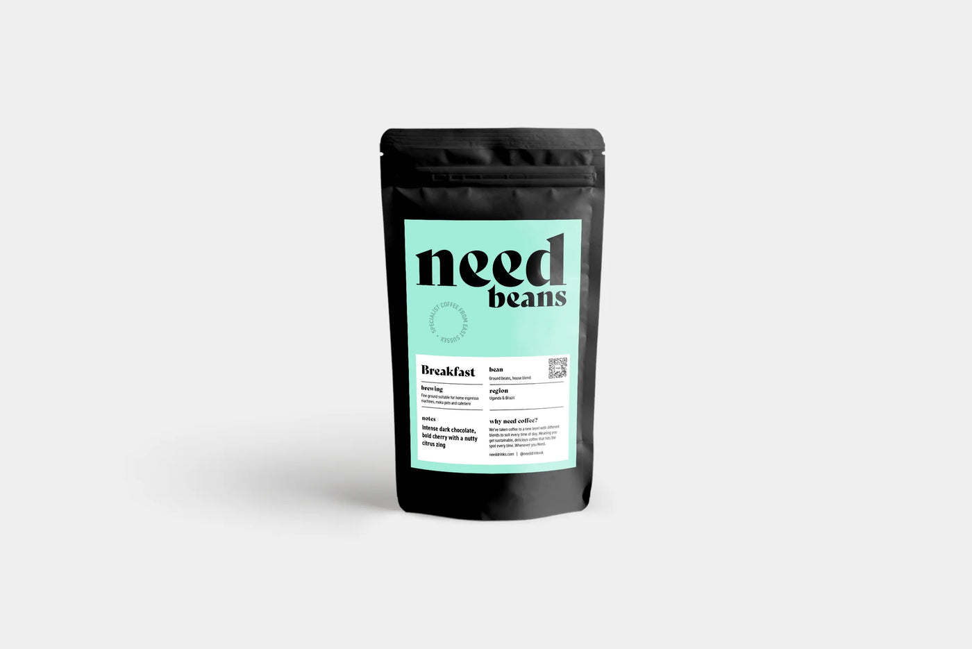 Black coffee packaging with 'need beans' branding on a light gray background