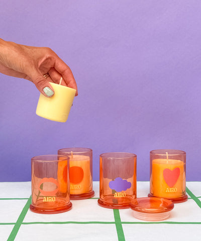 Set of colorful glass tumblers with AERO branding on a purple background