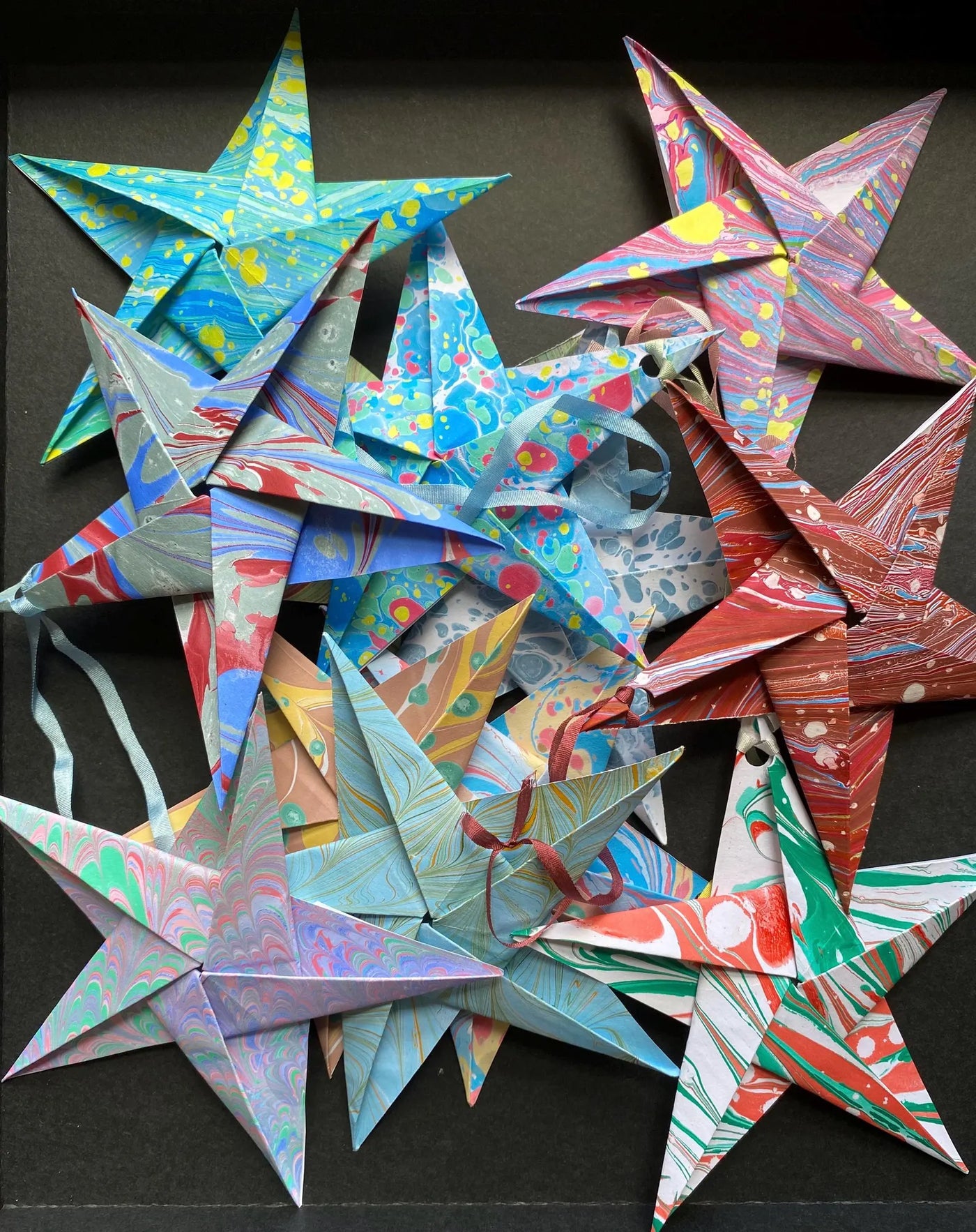 Colorful origami stars on a black background