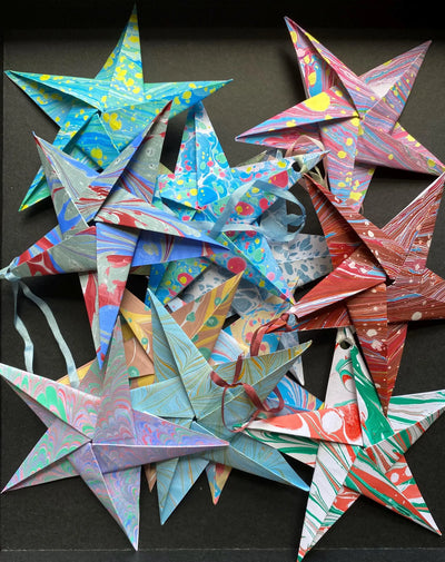 Colorful origami stars on a black background