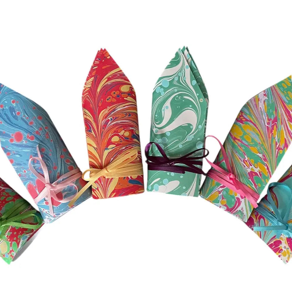 Colorful marbled paper windsocks on a white background