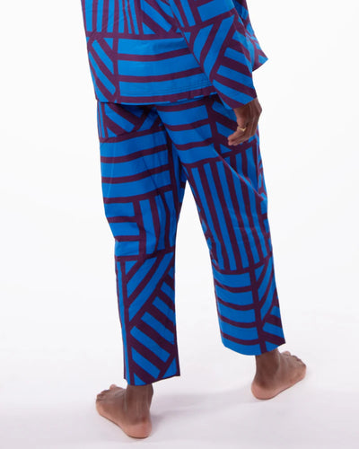 Blue and red geometric patterned pants on a white background
