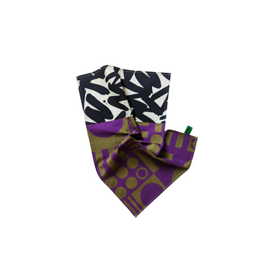 One abstract purple and green tea towel, on a white background.