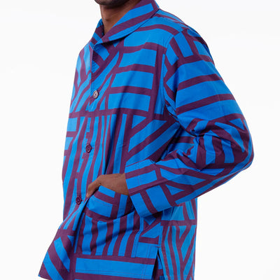 Person wearing a blue and purple patterned outfit on a white background
