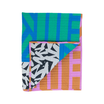 Colorful quilt with geometric patterns on a white background