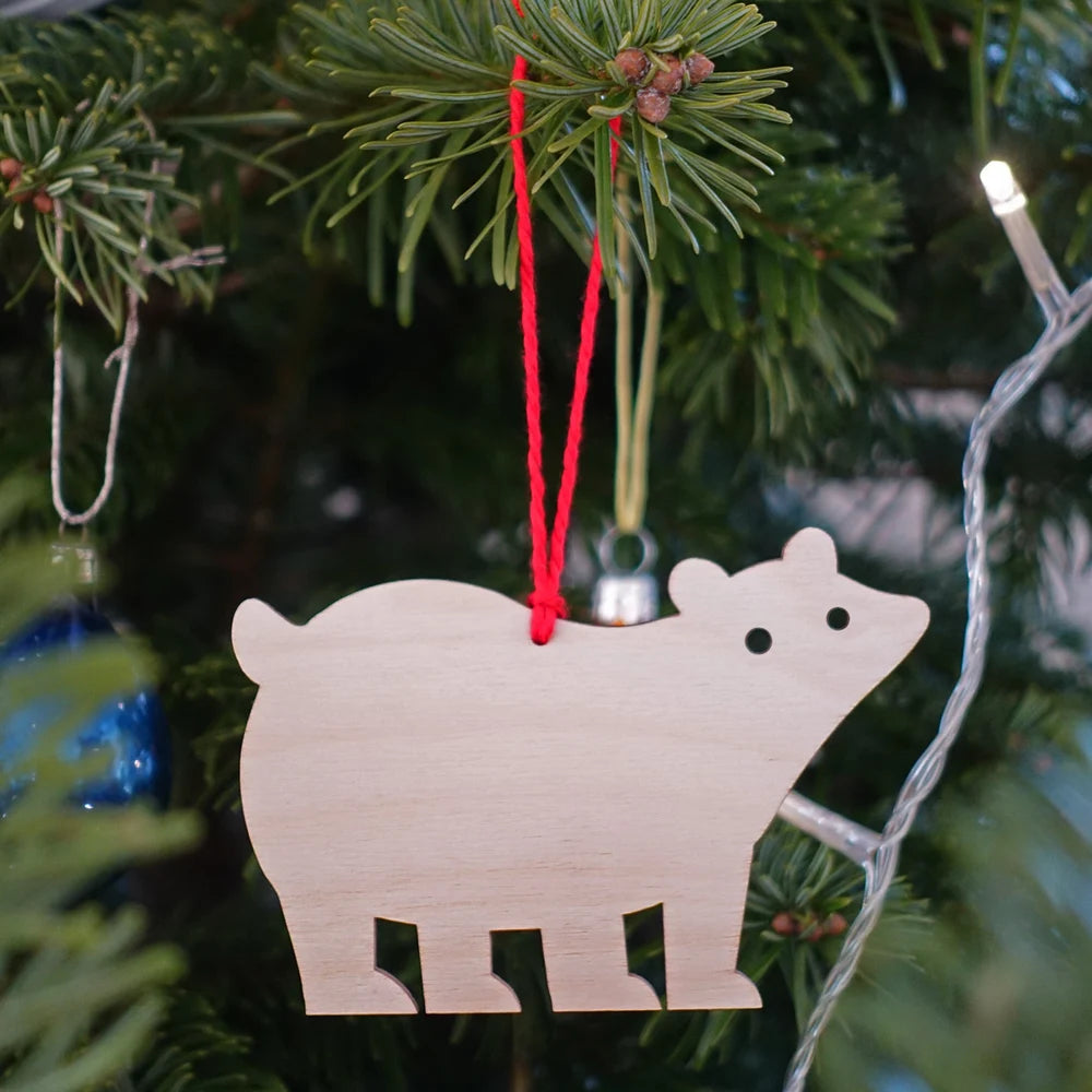 Wooden bear ornament hanging on a Christmas tree