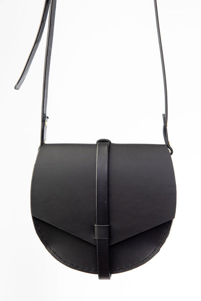 Black leather saddle bag with a strap on a white background