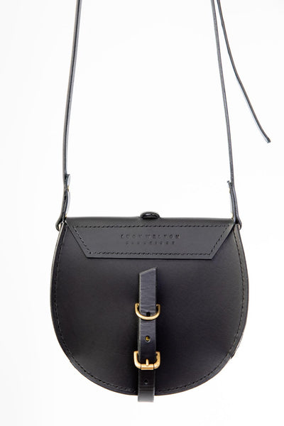 Black leather saddle bag with gold buckle on a white background