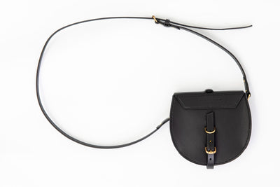Black leather bag with a strap on a white background