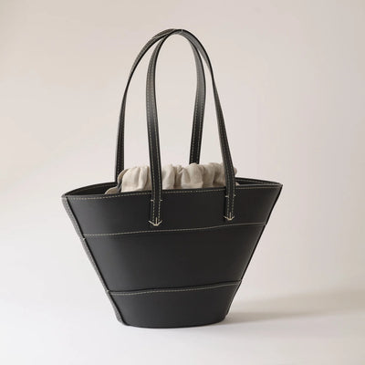 Black handbag on a light gray background