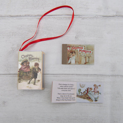 Vintage-style Christmas book with illustrations and a red ribbon on a wooden surface