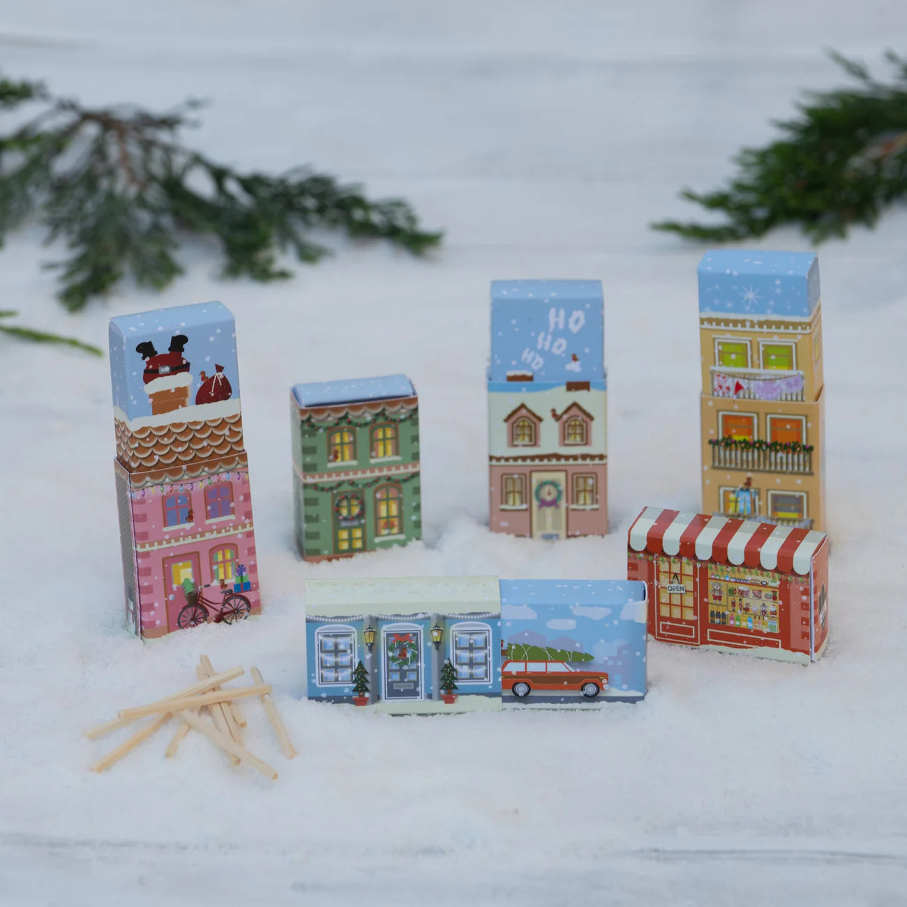 Set of colorful matchbox houses on a snowy background