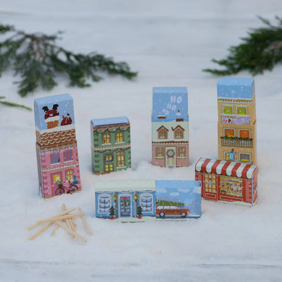 Set of colorful matchbox houses on a snowy background