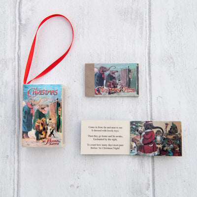 Set of Christmas-themed cards with a red ribbon on a white wooden surface