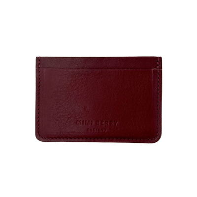 Red leather cardholder with 'Timberland' branding on a white background