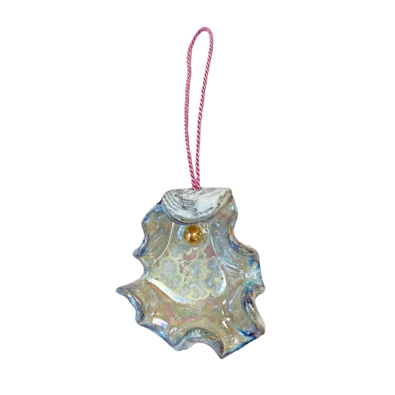Iridescent glass ornament shaped like a leaf with a pink string on a white background