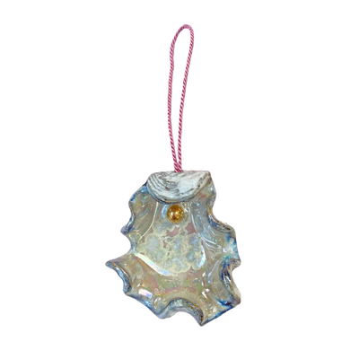 Iridescent glass ornament shaped like a leaf with a pink string on a white background