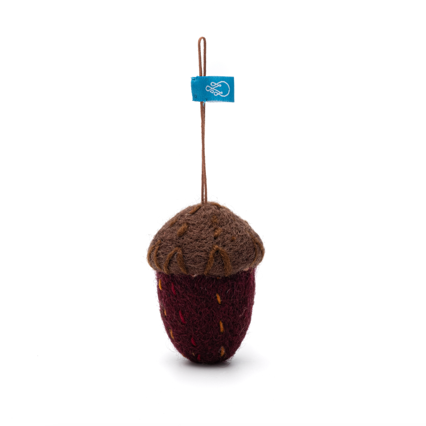 Knitted acorn-shaped ornament with a tag on a white background