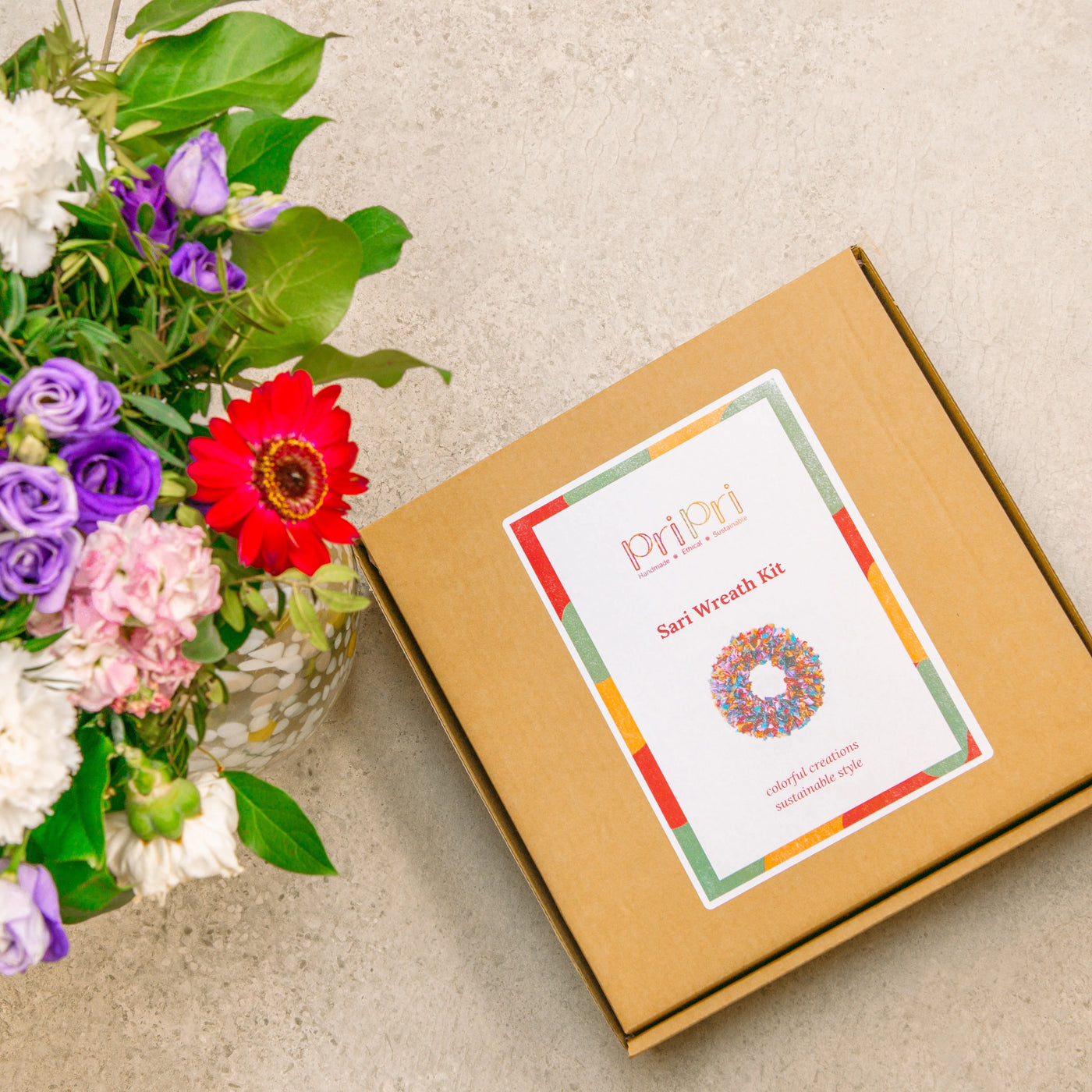 Sari Wreath Kit packaging with flowers on a light surface