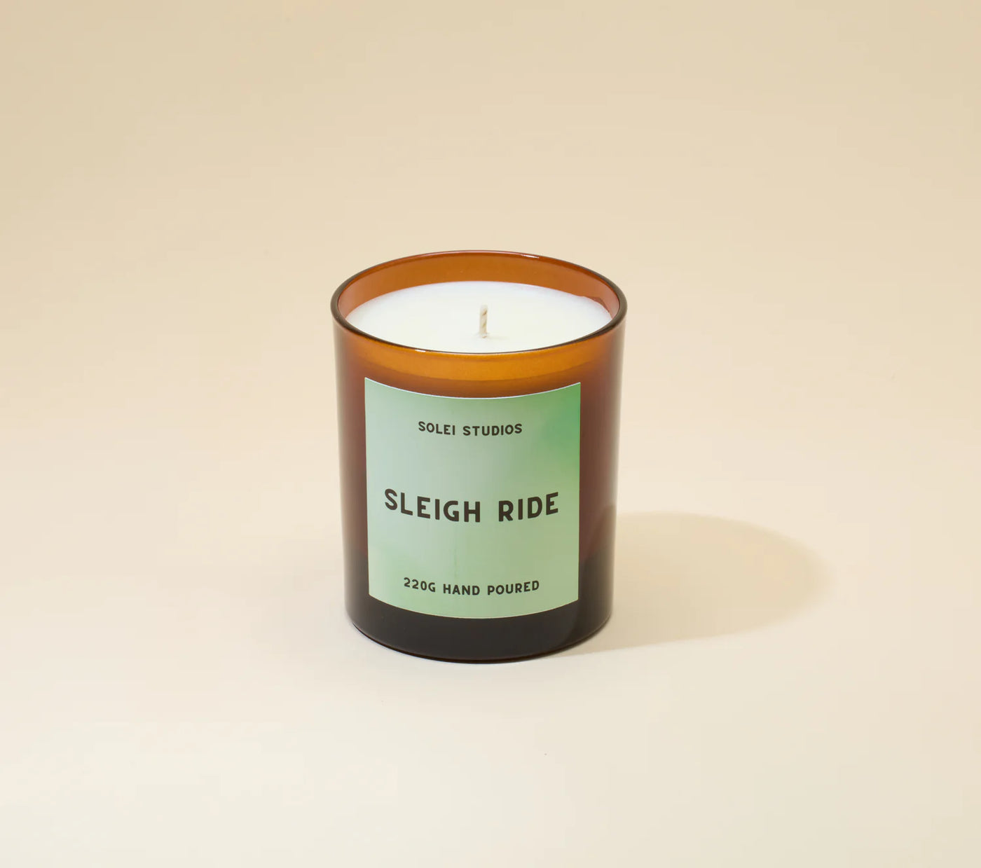 Candle with a label on a beige background
