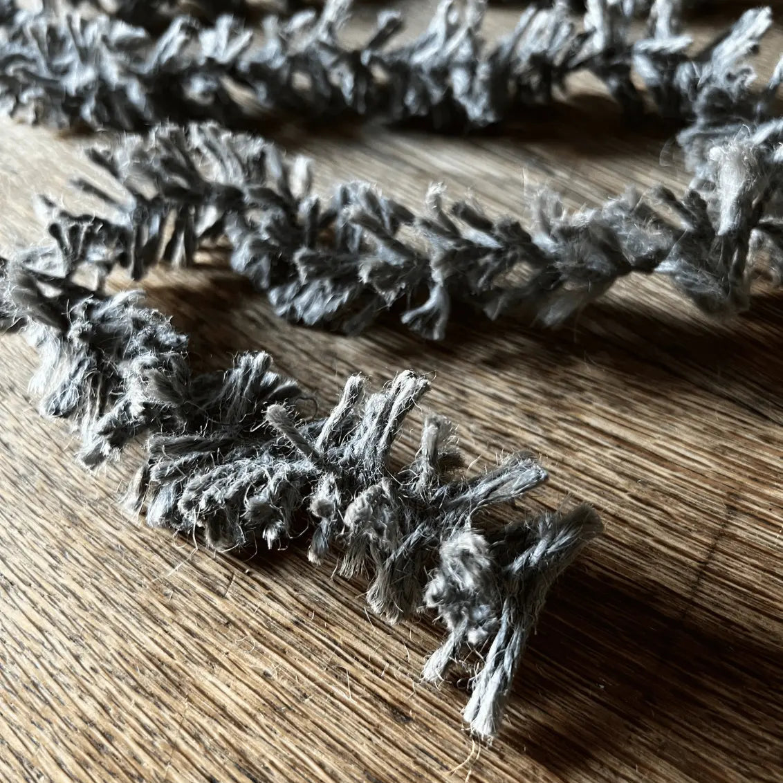 Close-up of metallic tinsel on a wooden surface