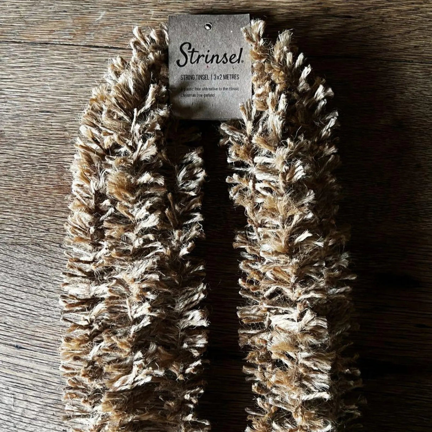 Coiled decorative rope with a label on a wooden surface