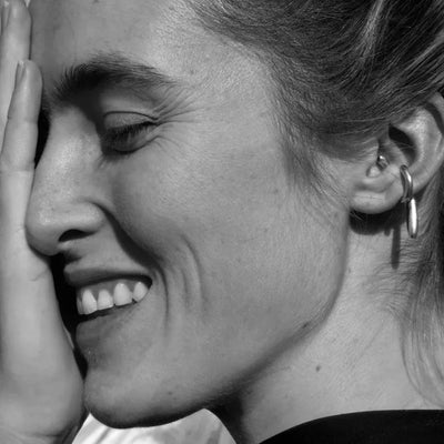 Black and white close-up of a person with hoop earrings