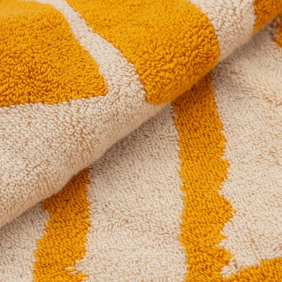 Close-up of a textured towel with orange and beige stripes