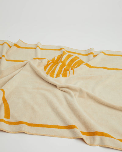 Beige towel with orange stripes on a white background