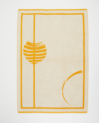 Beige rug with yellow abstract design on a white background