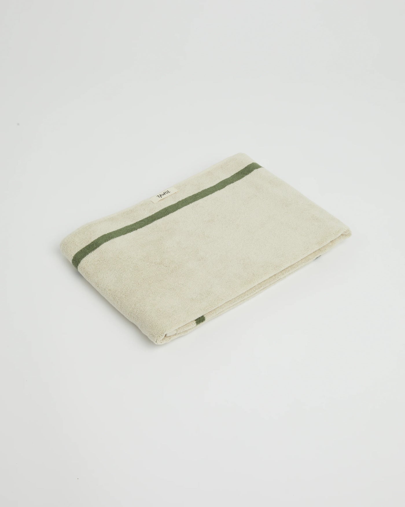 Beige towel with green stripe on a white background