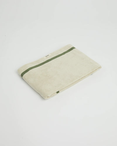 Beige towel with green stripe on a white background