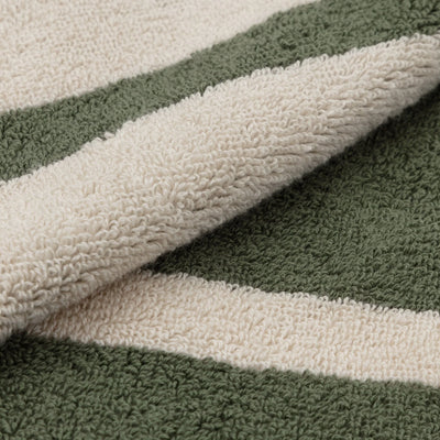 Close-up of a textured fabric with green and beige stripes