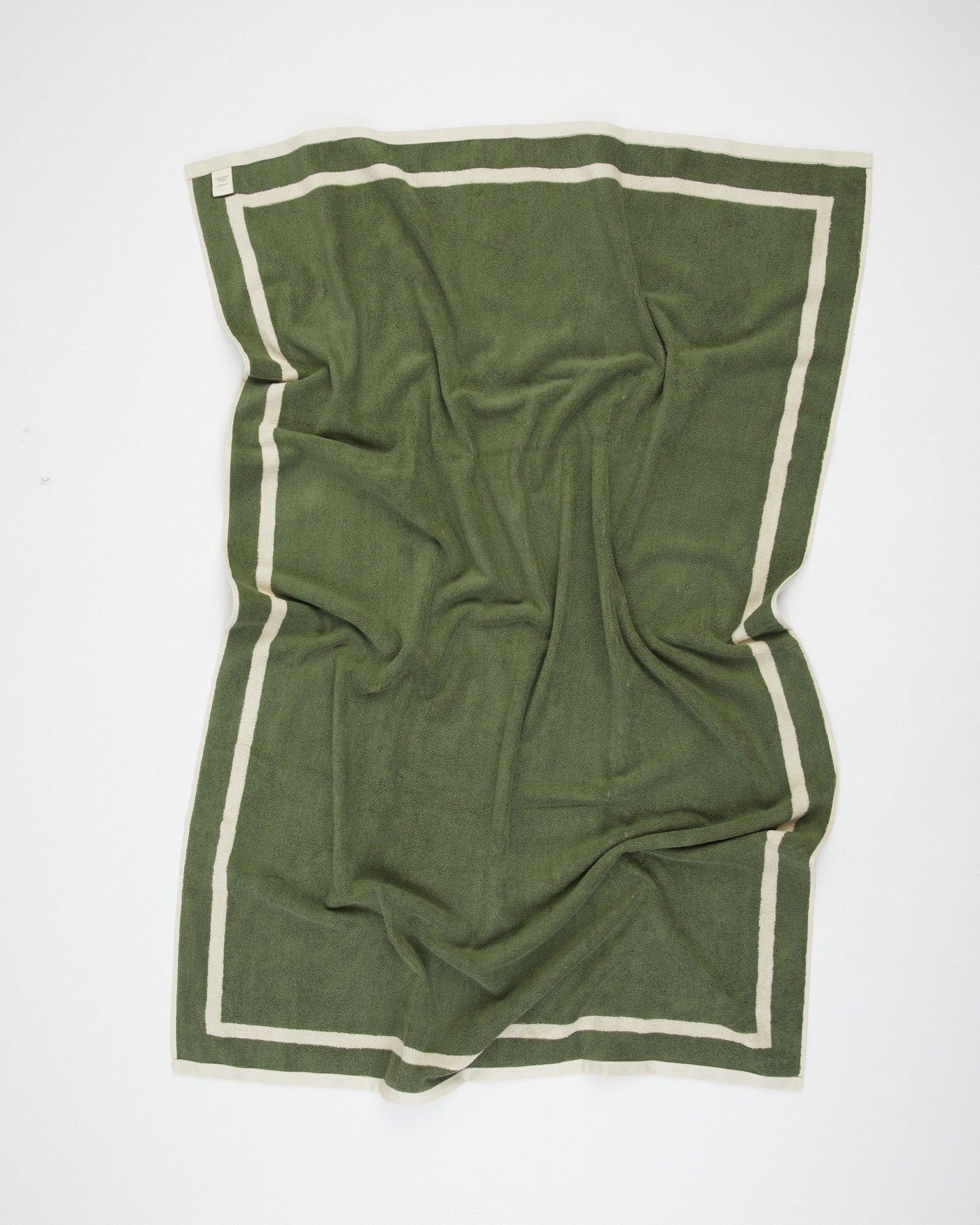 Green fabric with white border on a white background