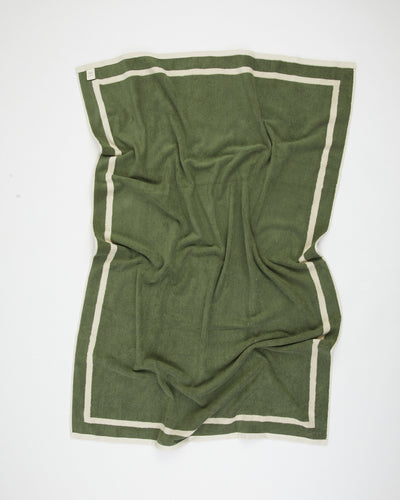 Green fabric with white border on a white background