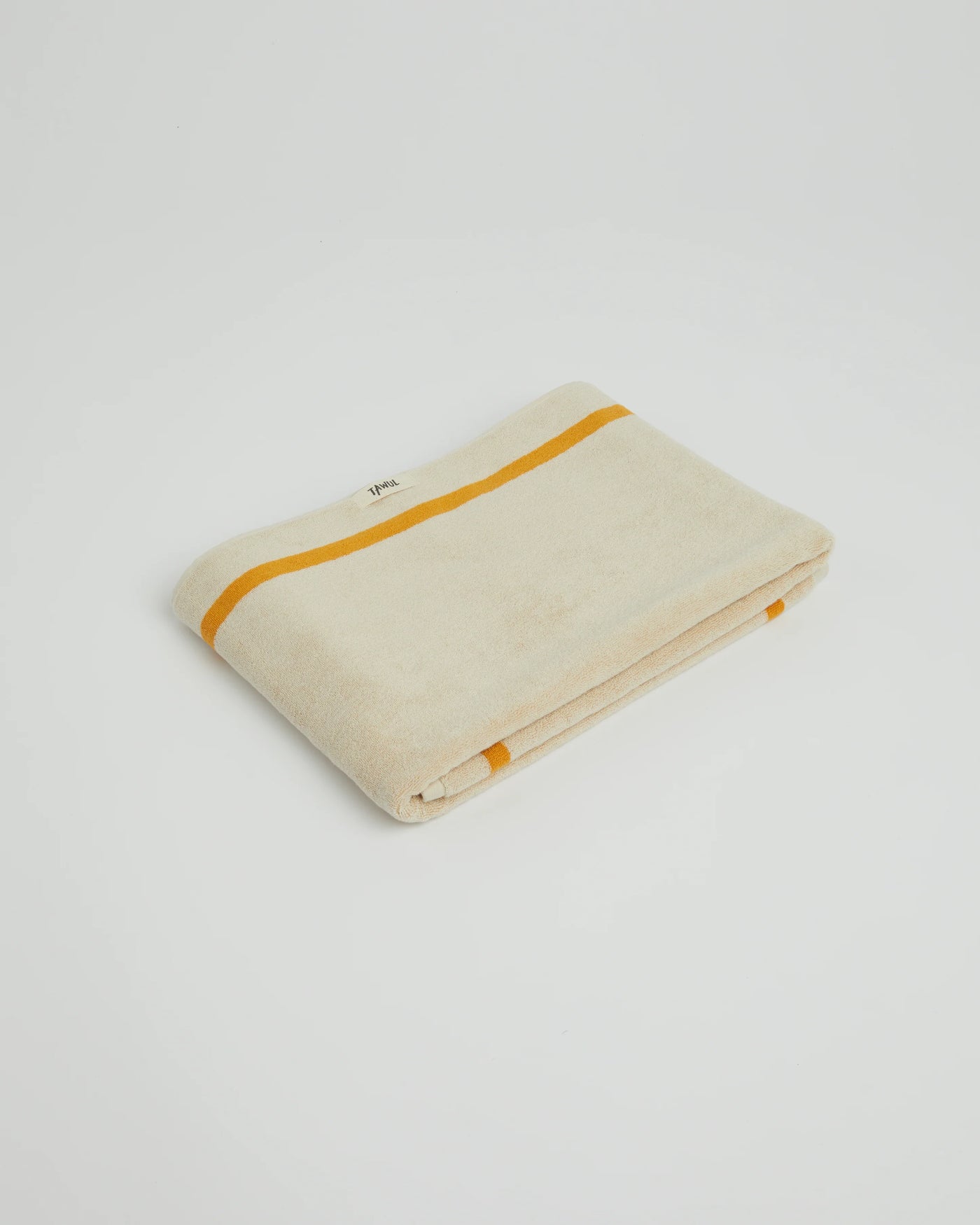 Beige towel with orange stripe on a light gray background