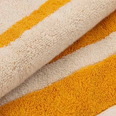 Close-up of a textured fabric with yellow and beige stripes