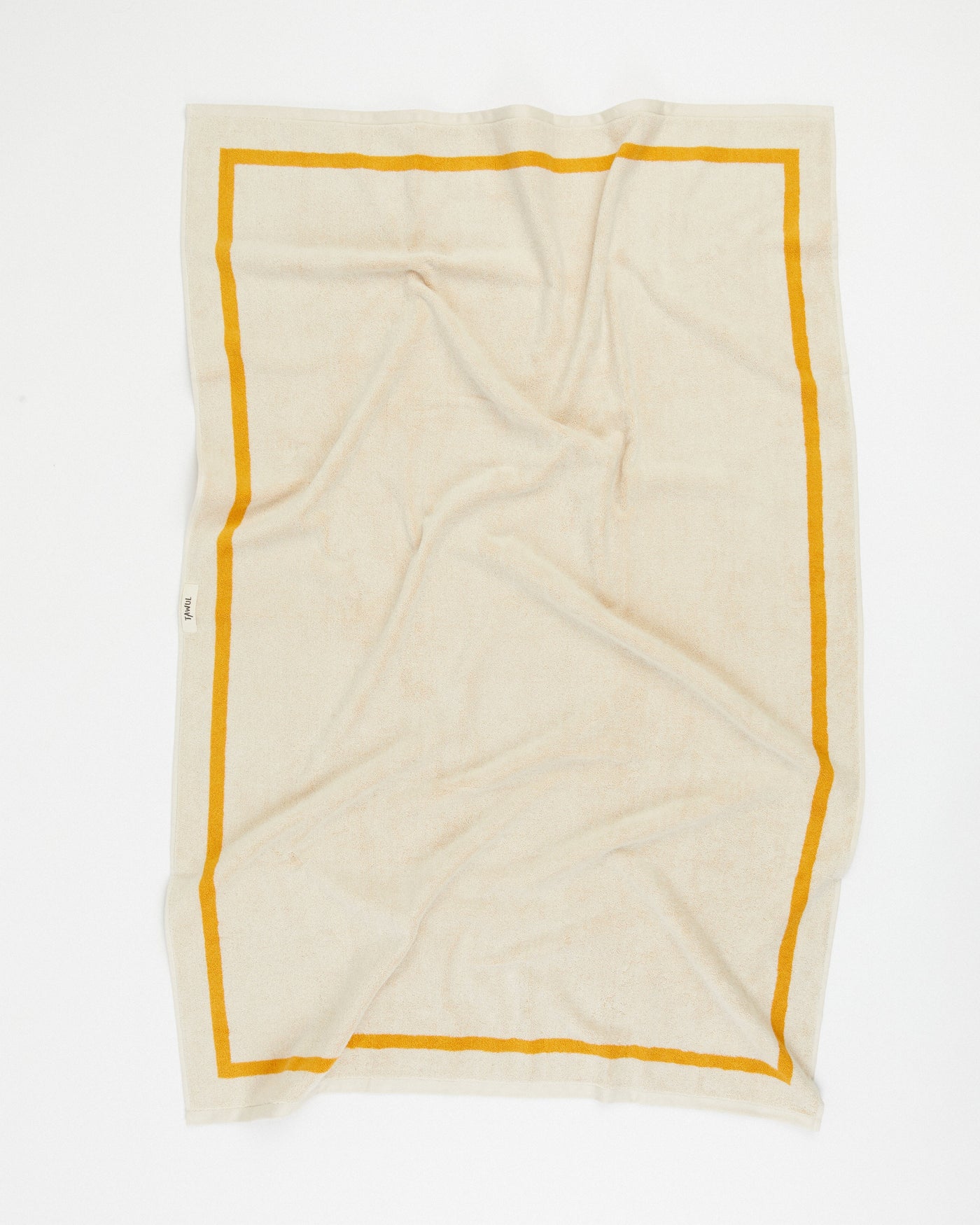 Beige towel with yellow border on a white background