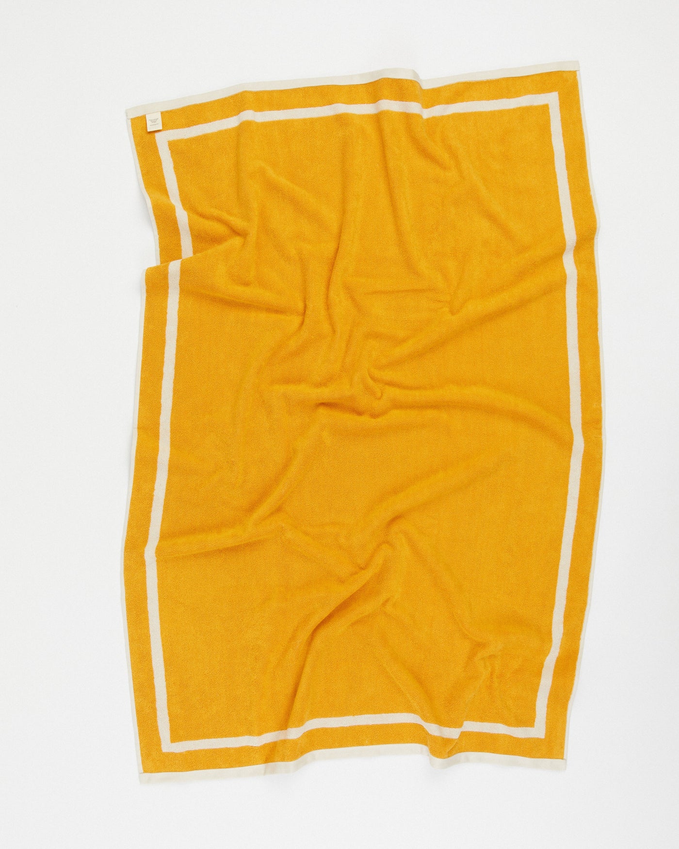 Yellow towel with white trim on a white background