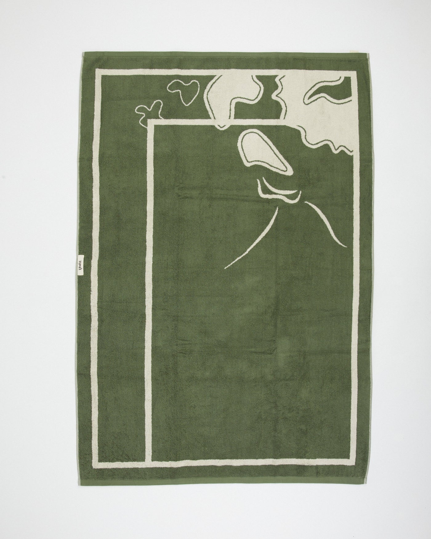 Green towel with white abstract design on a white background