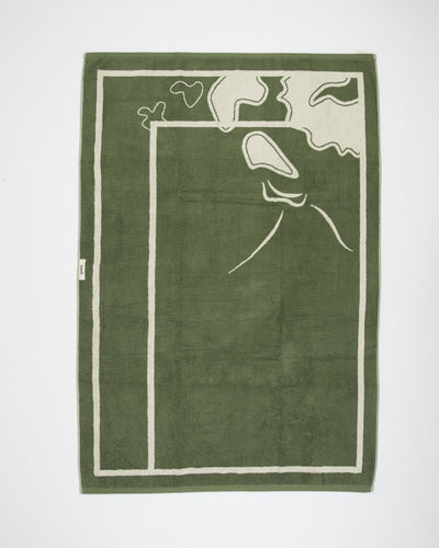 Green towel with white abstract design on a white background