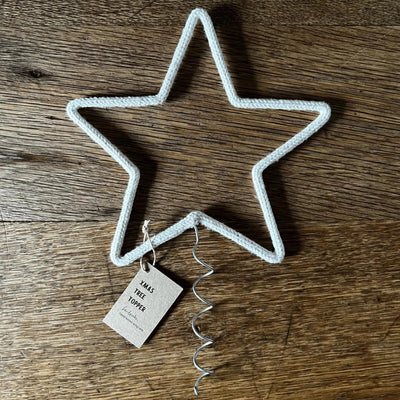 Star-shaped bottle opener with a tag on a wooden surface