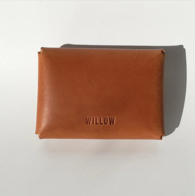 Brown leather pouch with 'WILLOW' branding on a white background
