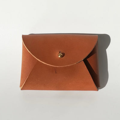 Brown leather pouch with a gold clasp on a white background