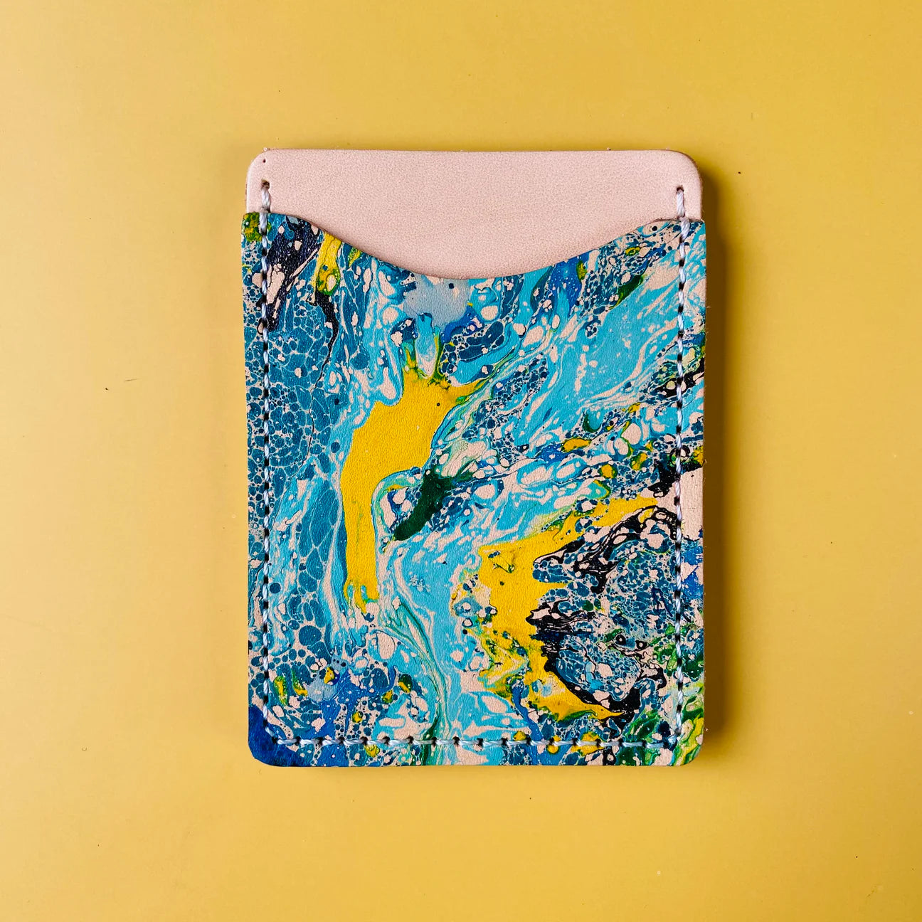 Marbled blue and yellow case on a yellow background